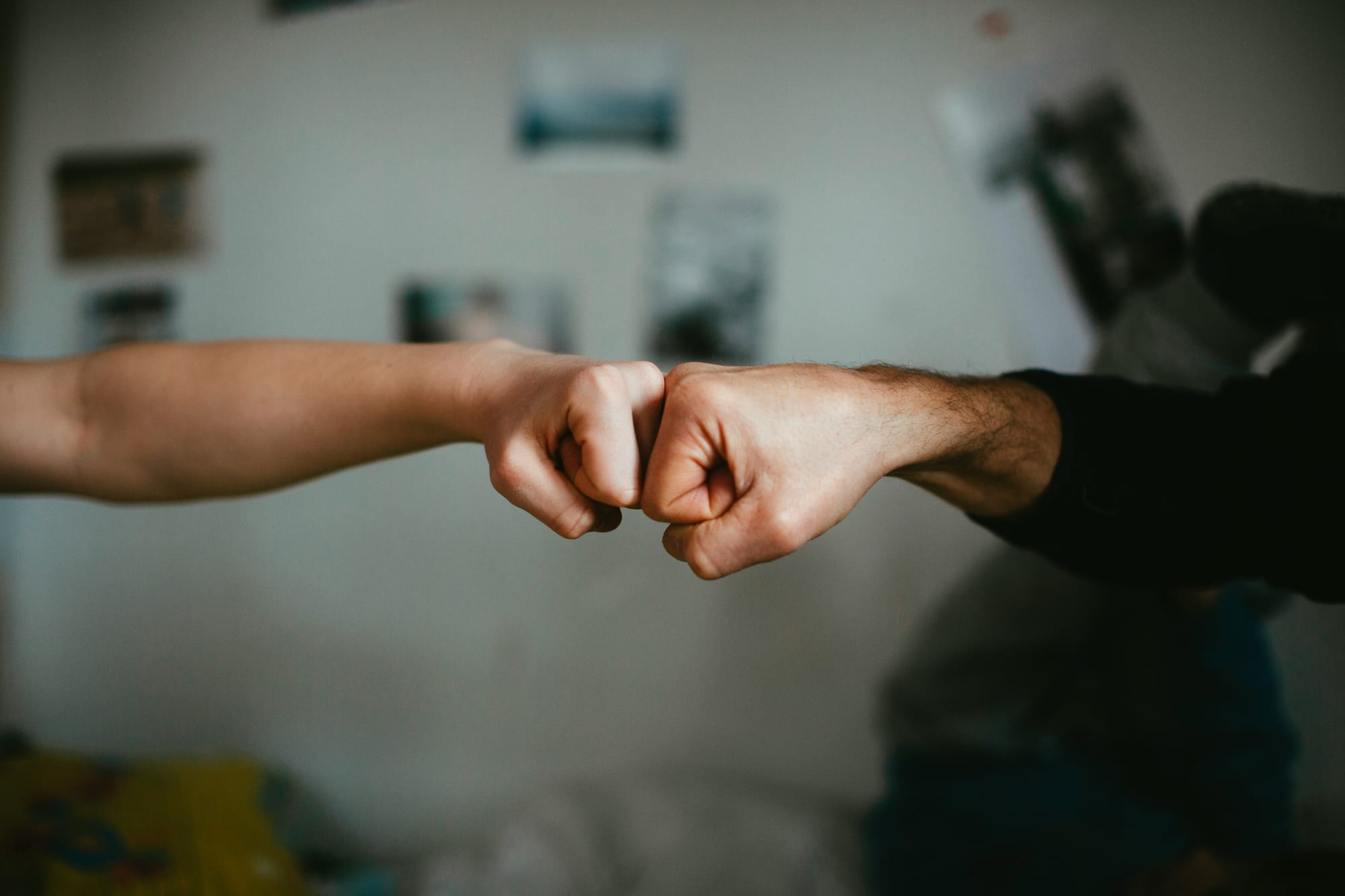 Two fists touching